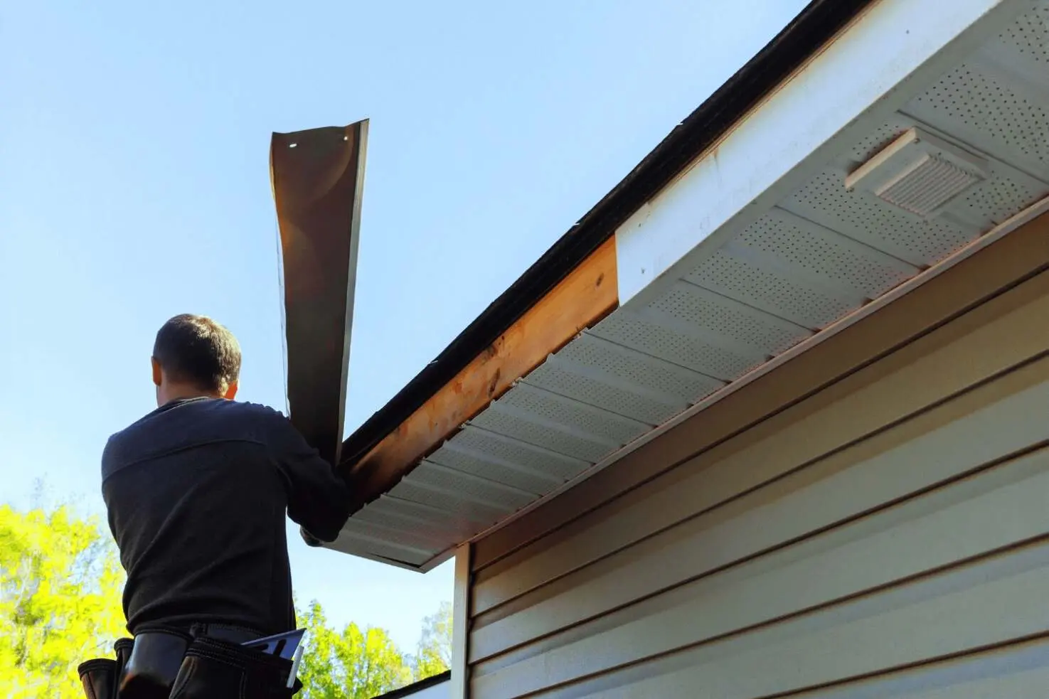 A photo demonstrating the steps to replace fascia boards on a house