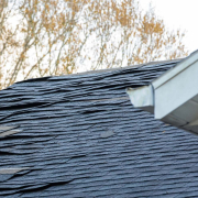 An illustration highlighting key indicators that a roof needs replacement, including visible damage and age.