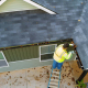 How to Compare Exterior Contractors in Alexandria, VA, Without Overpaying or Missing Red Flags 2 An illustration of a professional roofing contractor performing maintenance on a roof.