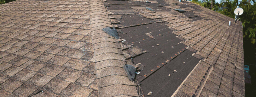 Alexandria Wind Uplift Prevention: Pro Strategies to Keep Water Out 1 A roof with several missing shingles, indicating potential wind damage