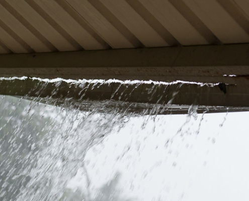 gutter-overflow Residential gutter overflowing during a storm
