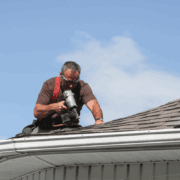 A professional roofer conducting a regular roof inspection.