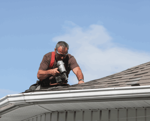 A professional roofer conducting a regular roof inspection.