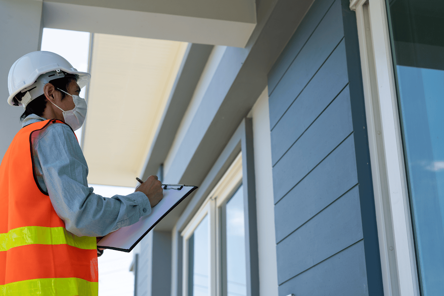 How to Quickly Fix Leak on Roof: A Practical Guide 2 A person inspecting a roof for leaks, looking for signs of roof damage.