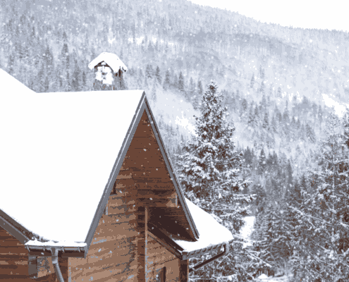A roofing crew working on a roof replacement during winter conditions.