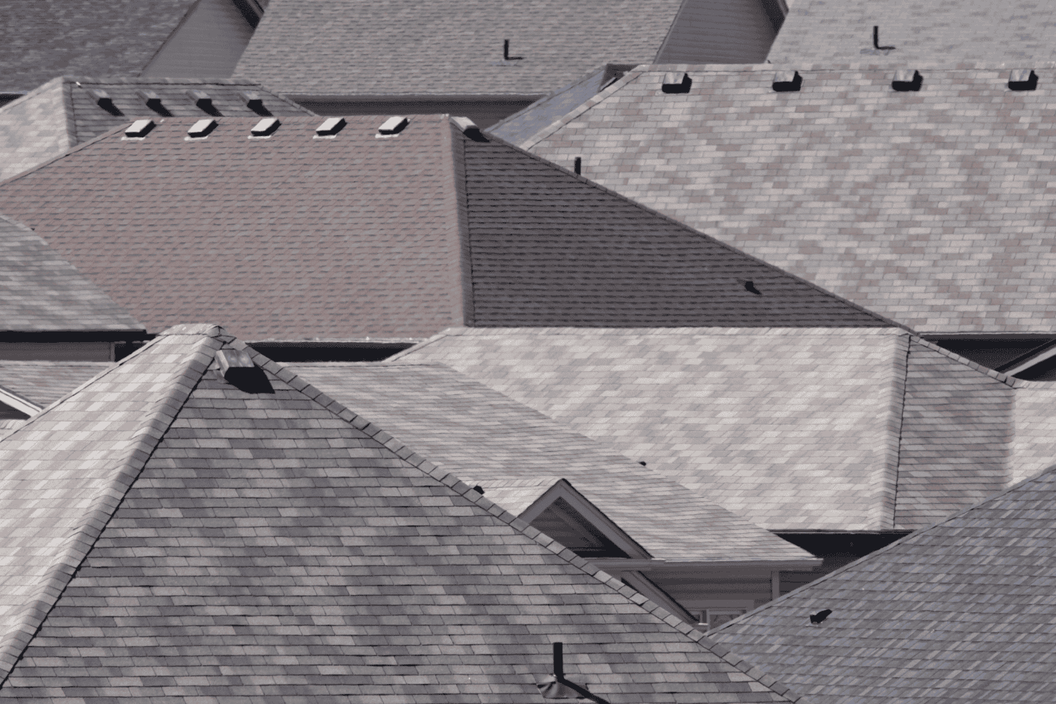 How Long Does a Roof Last? Average Lifespan by Material 2 Different types of roofs including asphalt shingles, metal roofs, and tile roofs.