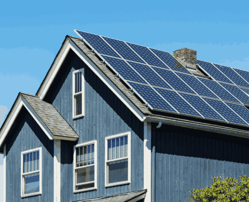 Solar shingles integrated into a roof, demonstrating energy efficiency.