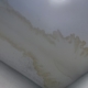 Brown water stain spreading across a bathroom ceiling corner