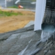 Rainwater pouring off a house roof edge past the gutter during a storm, Ocean City MD