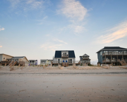 What Does It Take to Maintain a Rental at the Shore? 6 Row of raised beach rental cottages on an empty shore beach, Ocean City MD