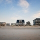 What Does It Take to Maintain a Rental at the Shore? 2 Row of raised beach rental cottages on an empty shore beach, Ocean City MD