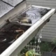 Why Do My Gutters Overflow Every Storm? 2 Gutter filled with rainwater overflowing over its edge during a storm